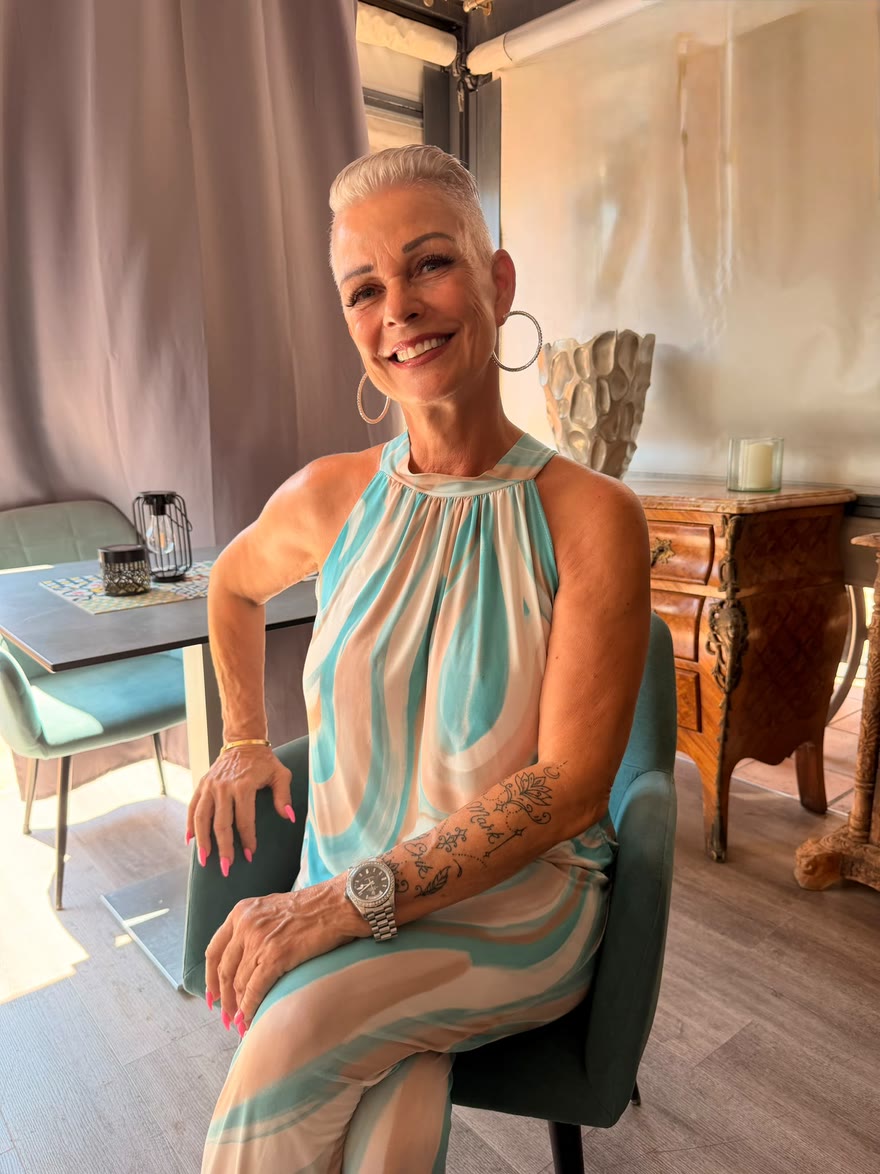 Renée Gorgoglione smiles at the camera, seated in her restaurant's dining room.