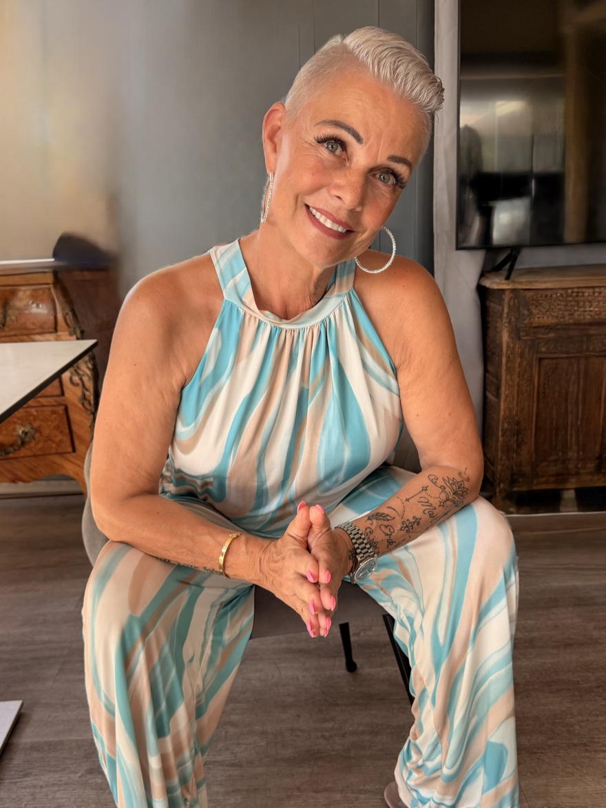 Renée Gorgoglione looks calmly and directly into the camera, her hands folded in front of her.